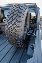 Load image into Gallery viewer, DV8 Offroad 2019+ Jeep Gladiator Universal Stand Up In-Bed Tire Carrier
