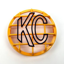 Load image into Gallery viewer, KC HiLiTES 6in. Round ABS Stone Guard for SlimLite/Daylighter Lights (Single) - Yellow/Black KC Logo
