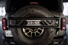 Load image into Gallery viewer, DV8 Offroad 21-23 Ford Bronco Spare Tire Guard &amp; Accessory Mount
